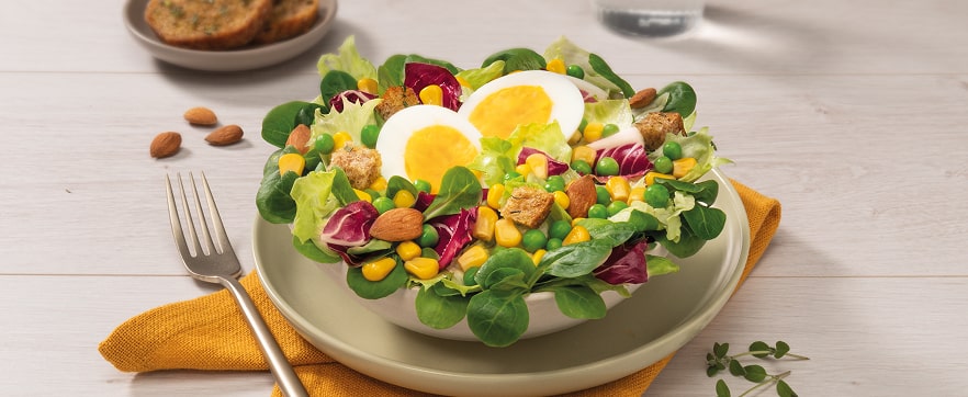 Insalatona con mais, piselli, uova sode e mandorle